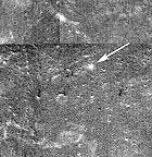 In this NASA image of the lunar surface, the white arrow indicates the site of Stuart's Crater.
