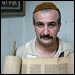 Emad Levy, the youngest Jewish man known to live in Baghdad, holds an antique Torah scroll.
