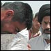Iraqi man cries holding plastic bag with the remains of a lost relative recovered from mass grave.