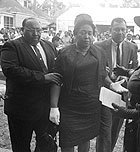 Mr. and Mrs. Alvin C. Robertson arrive for funeral services for their daughter Carol.