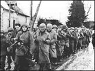 Captured GIs are marched through a Belgian village, Dec. 17, 1944. Captured GIs are marched through a Belgian village, Dec. 17, 1944.