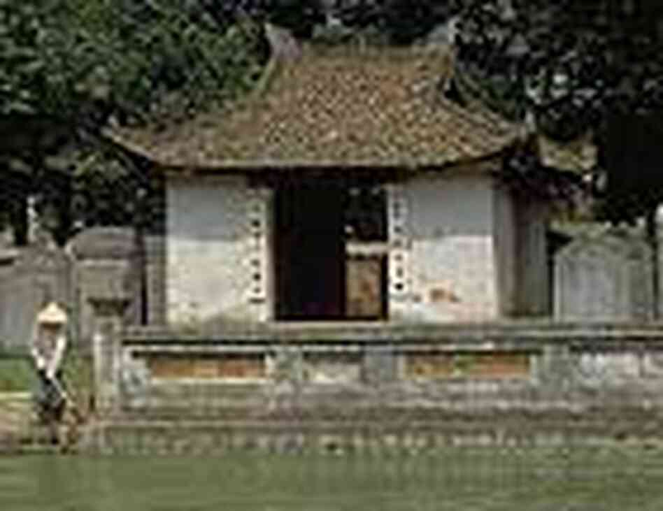 A woman cleans the steps to a pond at the Temple of Literature in Hanoi, Vietnam. A woman cleans the steps to a pond at the Temple of Literature in Hanoi, Vietnam.