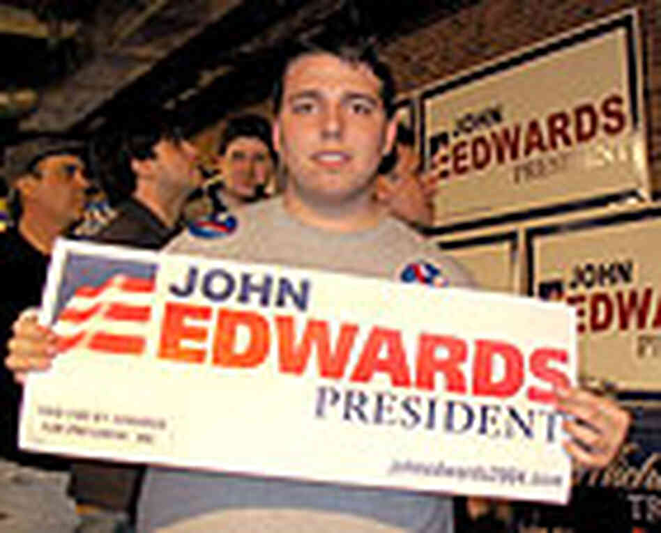 Robert Mack and his constant companion, an Edwards sign, at a victory party in South Carolina. Robert Mack and his constant companion, an Edwards sign, at a victory party in South Carolina.