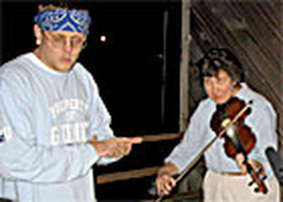 Hill Hop rapper Delivery and fiddler Beverly May rehearse on the porch at Appalshop Hill Hop rapper Delivery and fiddler Beverly May rehearse on the porch at Appalshop