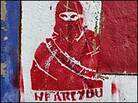 Graffiti on a wall in London's Banglatown neighborhood depicts an Islamist fighter.