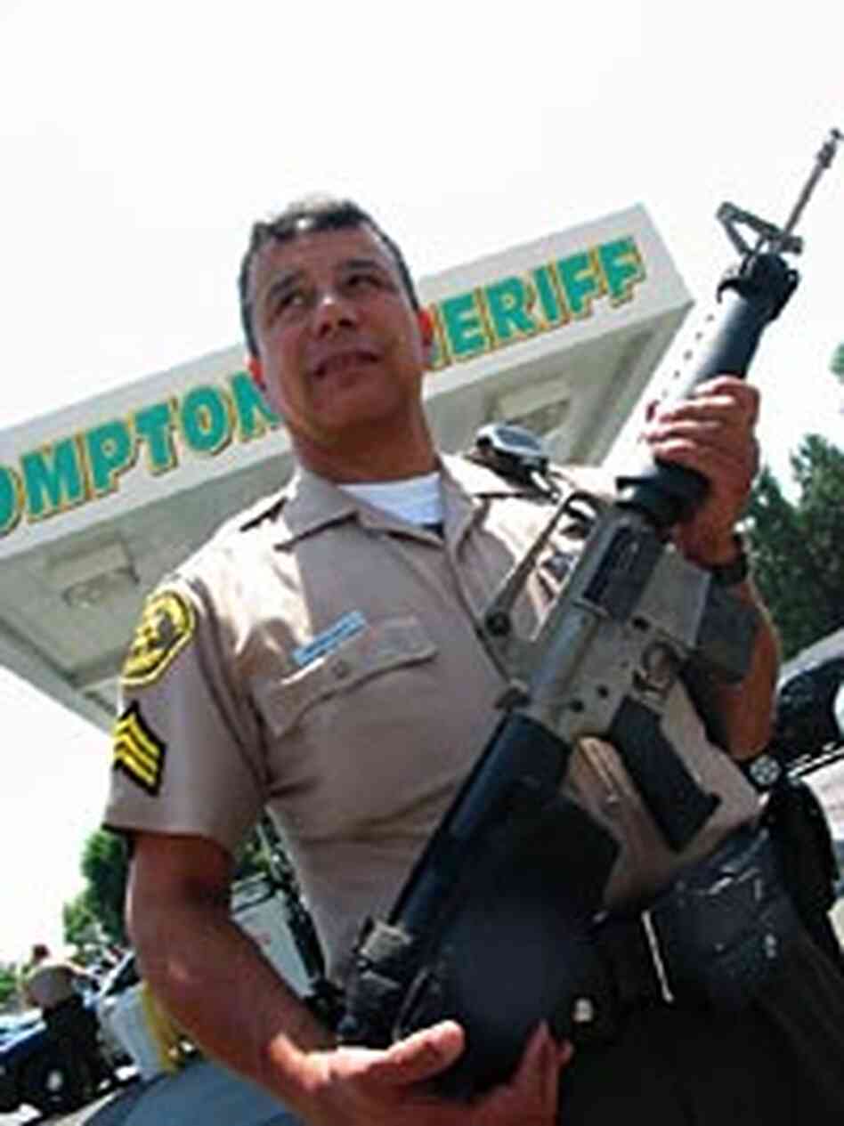 L.A. County Sheriff's Sgt. John Rodriguez patrols Compton armed with a military-style assault rifle. L.A. County Sheriff's Sgt. John Rodriguez patrols Compton armed with a military-style assault rifle.