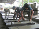 Workers building new homes in a factory. Credit: Michael Sullivan, NPR. Workers building new homes in a factory. Credit: Michael Sullivan, NPR.