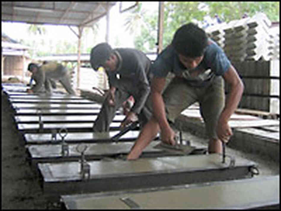 Workers building new homes in a factory. Credit: Michael Sullivan, NPR. Workers building new homes in a factory. Credit: Michael Sullivan, NPR.