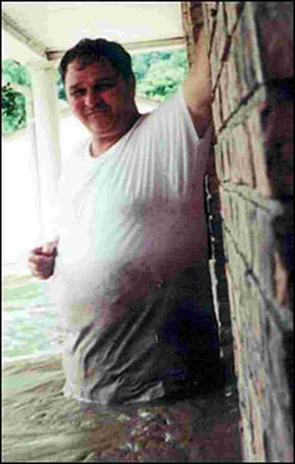 Harold Worley stands in water during the July 2001 flood in Mullens, W.Va. Harold Worley stands in water during the July 2001 flood in Mullens, W.Va.