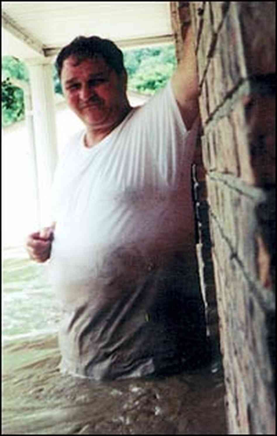 Harold Worley stands in water during the July 2001 flood in Mullens, W.Va. Harold Worley stands in water during the July 2001 flood in Mullens, W.Va.
