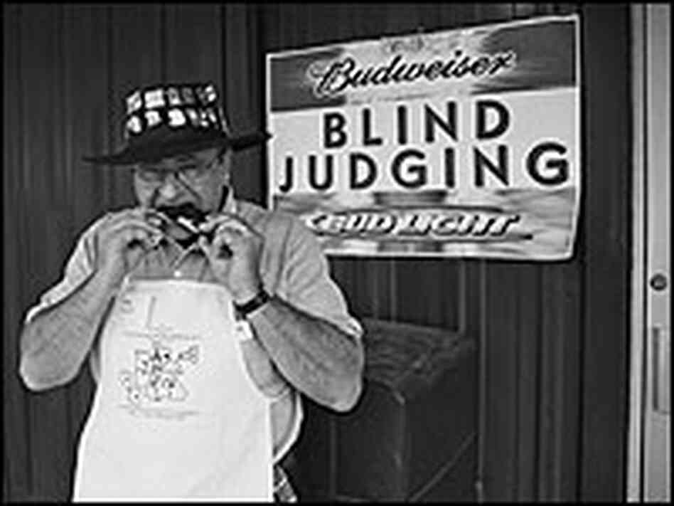 Barbecue judge Hap Zook samples a rib during competition. Barbecue judge Hap Zook samples a rib during competition.