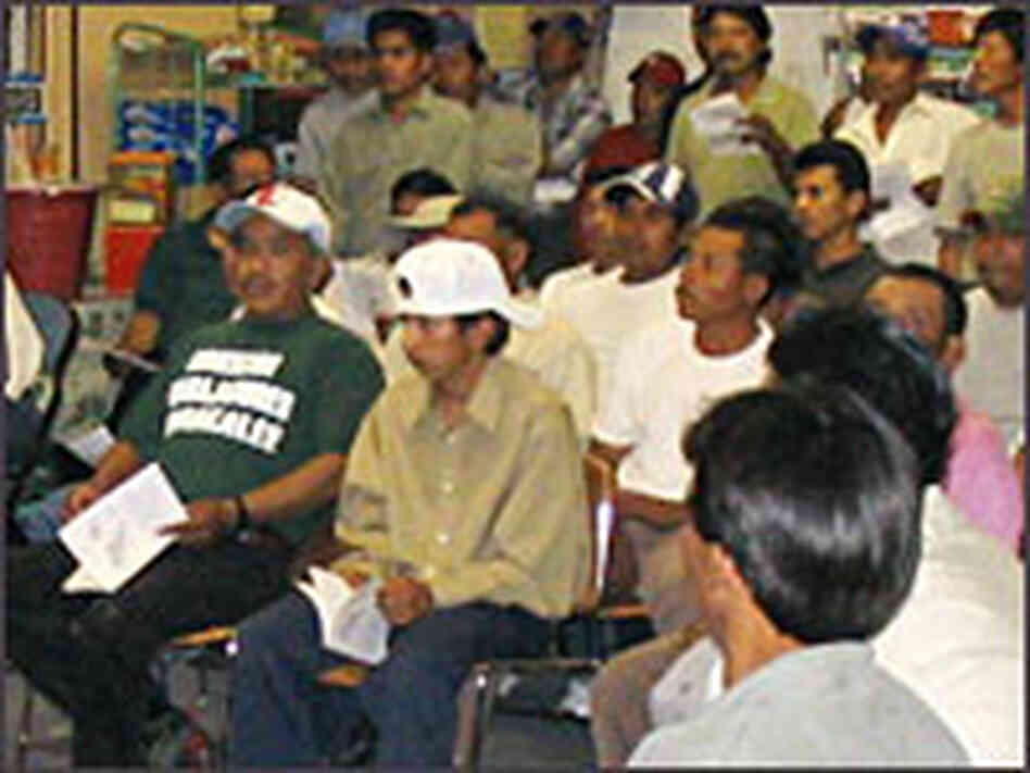 Workers attend a meeting to learn about their rights under the new agreement with Yum Brands. Workers attend a meeting to learn about their rights under the new agreement with Yum Brands.