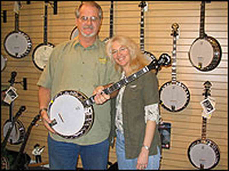 Greg and Janet Deering pose with a banjo in their showroom Greg and Janet Deering pose with a banjo in their showroom