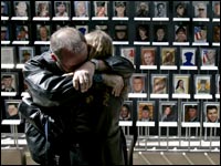 Rodney Nightingale and his wife Towina Nightingale, of Highland, Ind., embrace after seeing a portrait of her son, Army Ranger Nathan Stahl, at the 