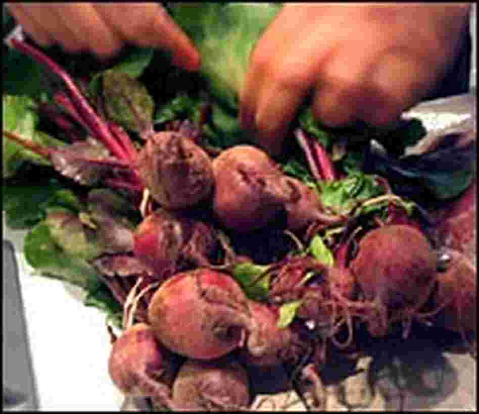 Mark Bittman prepares to separate freshly picked beets from their red stems and green leaves. Mark Bittman prepares to separate freshly picked beets from their red stems and green leaves.
