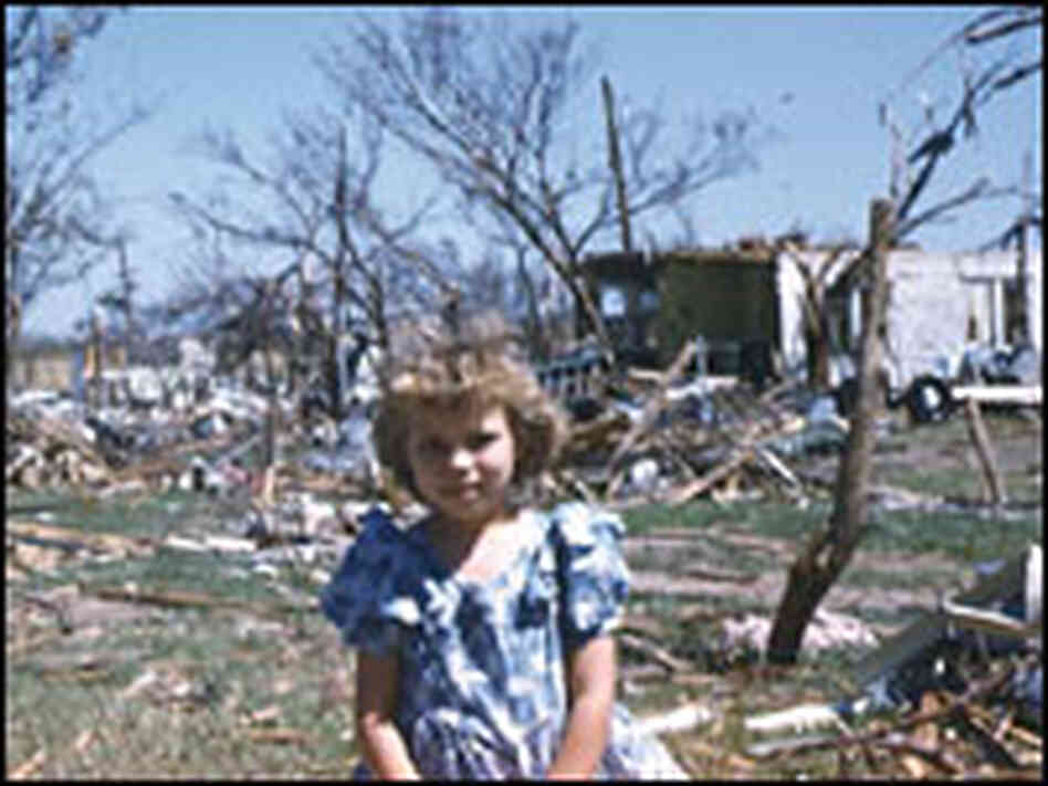 A young girl stands in front of buildings laid waste by the tornado that ripped through Udall, Kan. A young girl stands in front of buildings laid waste by the tornado that ripped through Udall, Kan.