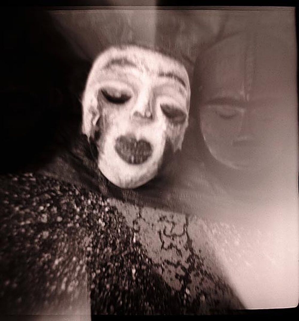 Photo of a mask taken with a toy camera, with distinctive "light leak" highlights