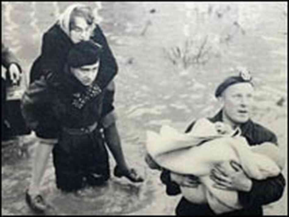 Dutch soldiers help evacuate flooded areas after a storm burst miles of levees in 1953.