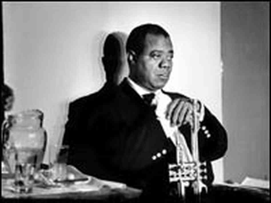 Louis Armstrong, caught in a reflective moment, his shadow against a white wall.