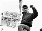 A student holds a "Deaf President Now" poster, in 1988. A student holds a "Deaf President Now" poster, in 1988.