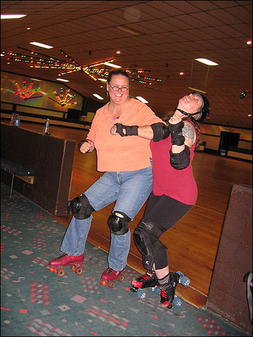 Debbie Elliott pretends to elbow a Charm City Roller Girl.