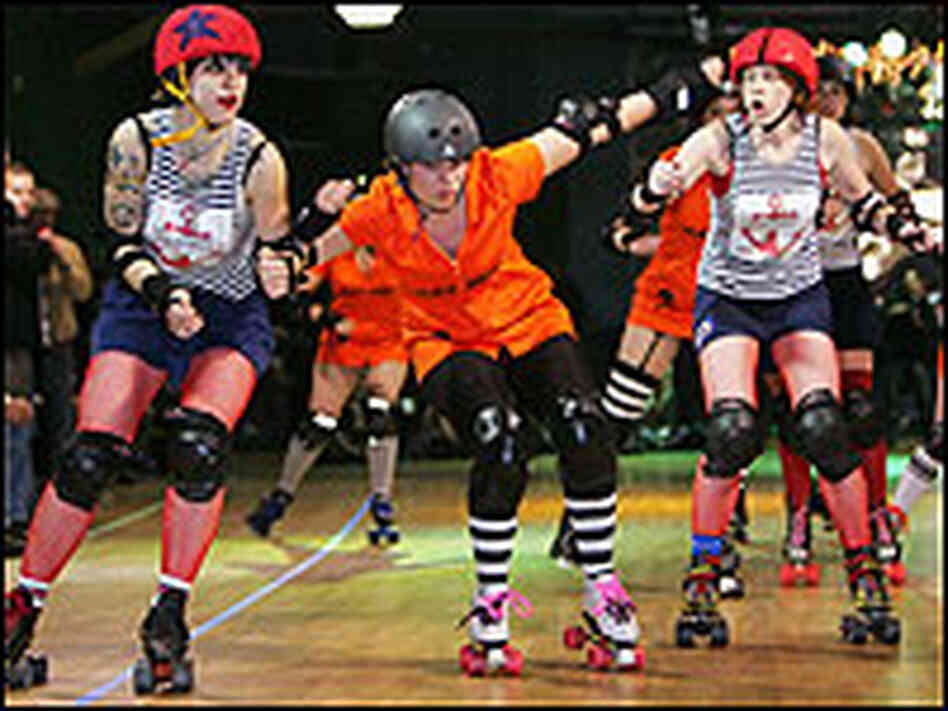 A jammer tries to break through two blockers in Gotham Girls Roller Derby action in the Bronx, N.Y.