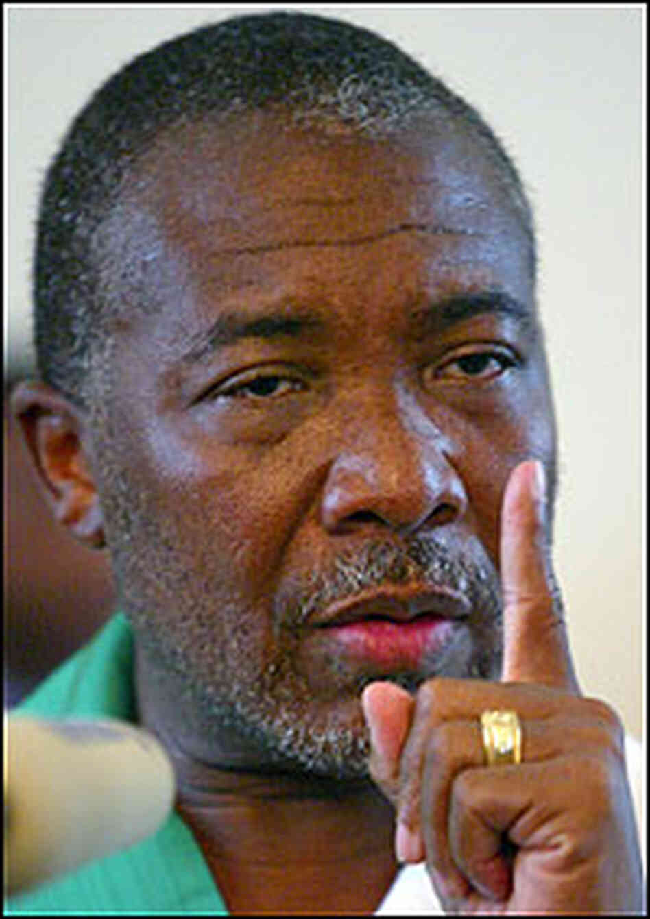 Charles Taylor holds up a finger as he says goodbye to Liberia. Charles Taylor holds up a finger as he says goodbye to Liberia.