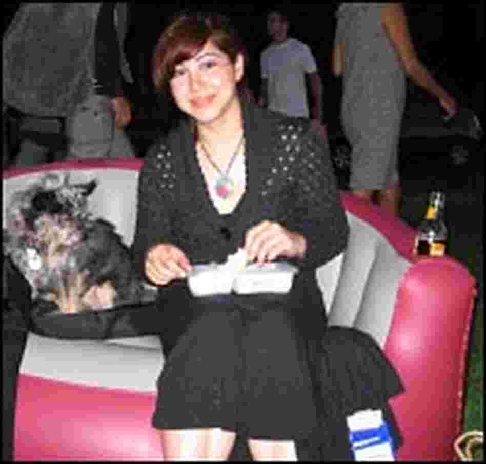 Gisella Centanaro and her yorkie-chihuahua mix Mr. T on her inflatable loveseat