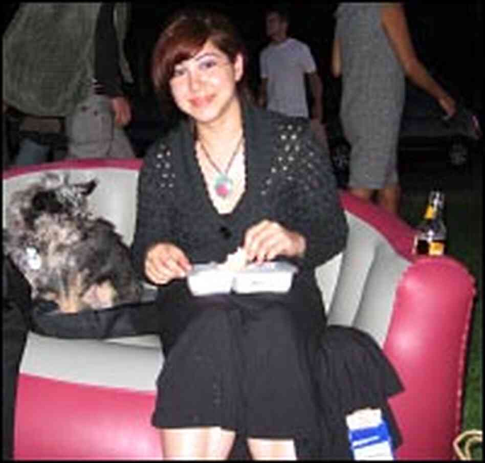 Gisella Centanaro and her yorkie-chihuahua mix Mr. T on her inflatable loveseat
