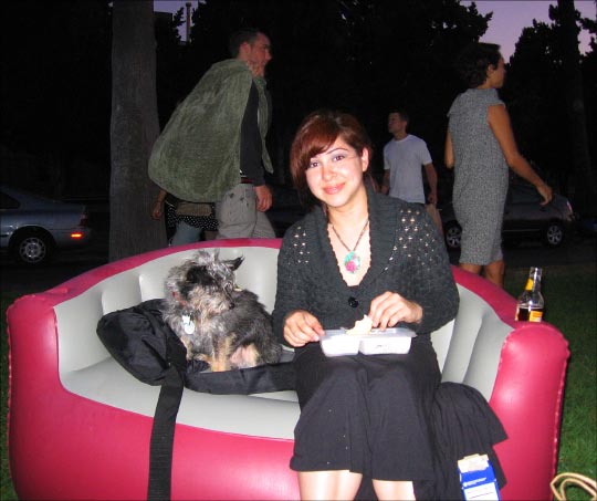 Gisella Centanaro and her yorkie-chihuahua mix Mr. T on her inflatable loveseat