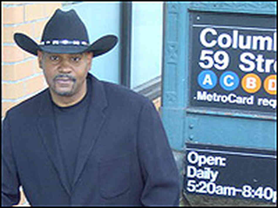 Allan Harris, in cowboy hat, outside a NYC subway station. Allan Harris, in cowboy hat, outside a NYC subway station.