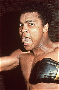 A 1963 photo finds Muhammad Ali in a familar pose, shouting at the camera.