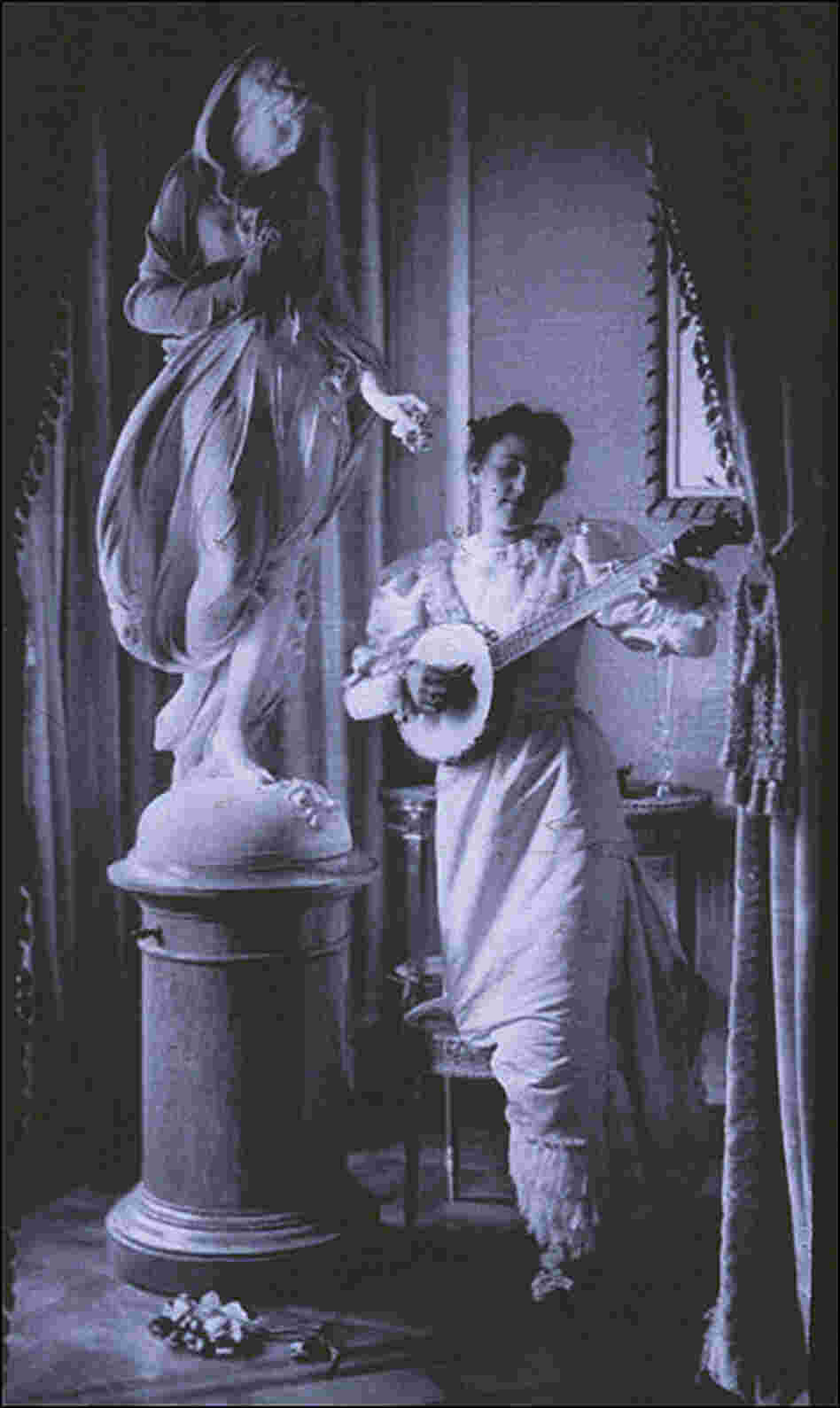 'Miss Apperson' playing banjo beside statue of Flora in niche of Sen. George Hearst's residence. 'Miss Apperson' playing banjo beside statue of Flora in niche of Sen. George Hearst's residence.
