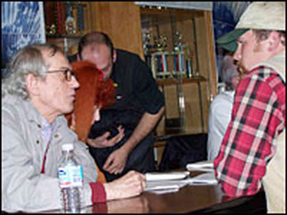 Christo talks with a local resident in Colorado at a community meetings about the project. Christo talks with a local resident in Colorado at a community meetings about the project.