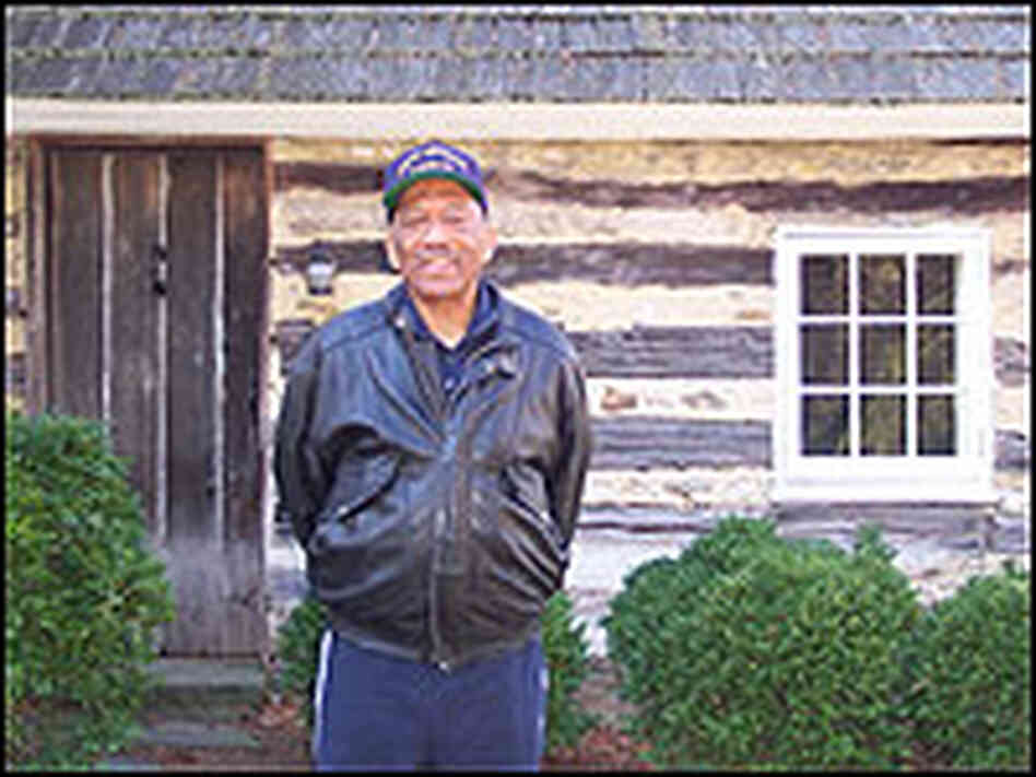 Jim Henson outside the Maryland cabin where his relative, Josiah Henson, lived as a slave.