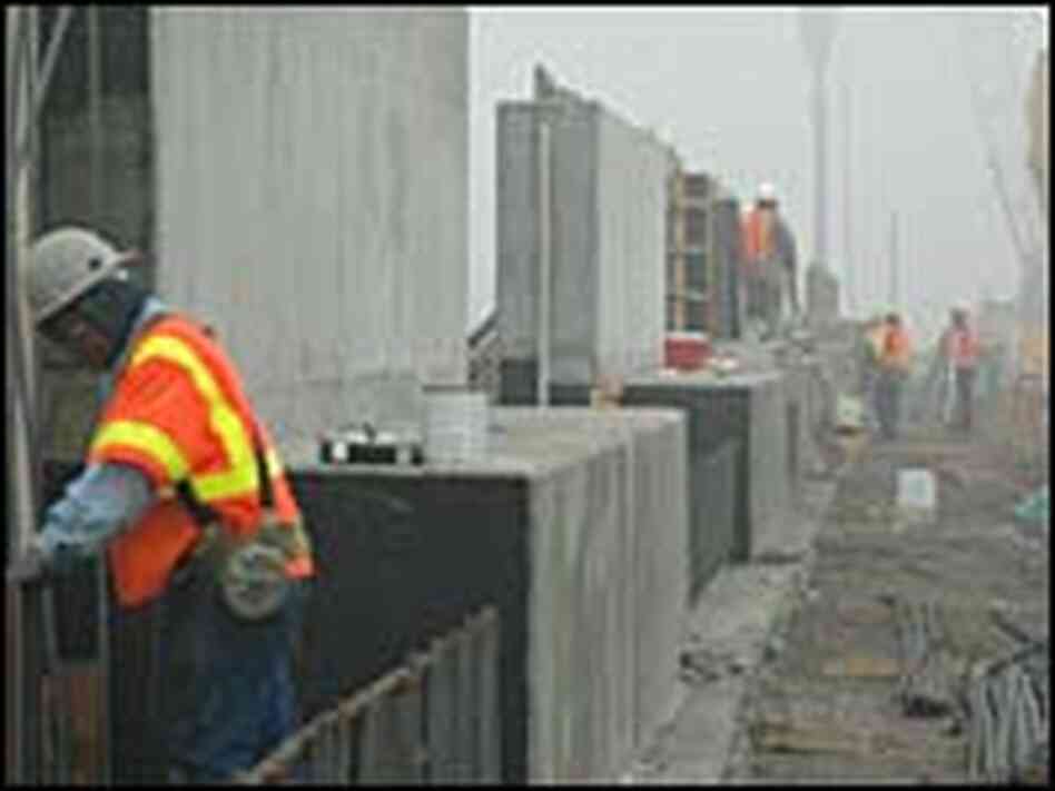 Workers construct L-walls for a levee that was breached in New Orleans East Workers construct L-walls for a levee that was breached in New Orleans East