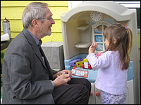 Analia Reutter plays with Professor Howard Mielke in her backyard.