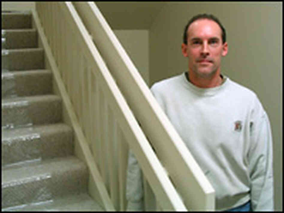 Dan Simon poses by a railing he crafted at a center for abused children. Dan Simon poses by a railing he crafted at a center for abused children.