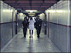 Guards escort an prisoner out of his solitary-confinement cell Guards escort an prisoner out of his solitary-confinement cell