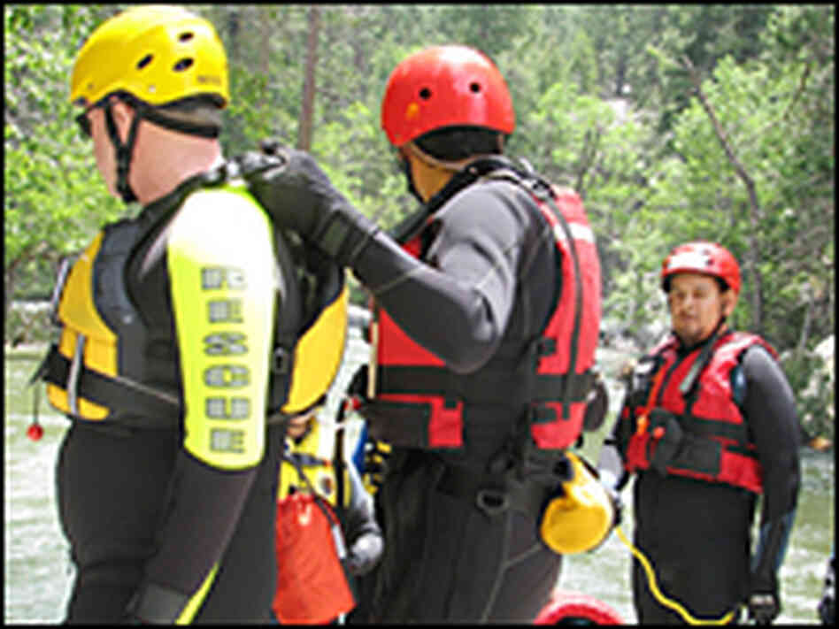 National park rangers wear bright wetsuits and hard helmets to protect themselves 