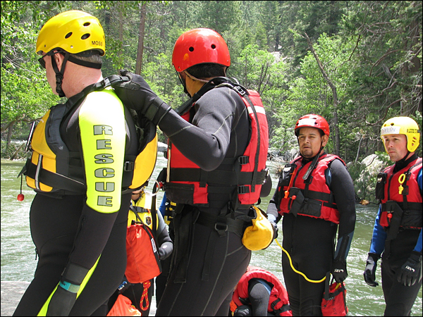 National park rangers wear bright wetsuits and hard helmets to protect themselves 