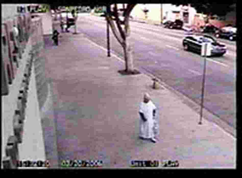 The woman, identified as Carol Reyes of Gardena, shuffles along the sidewalk toward the entrance to The woman, identified as Carol Reyes of Gardena, shuffles along the sidewalk toward the entrance to