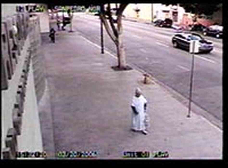 The woman, identified as Carol Reyes of Gardena, shuffles along the sidewalk toward the entrance to The woman, identified as Carol Reyes of Gardena, shuffles along the sidewalk toward the entrance to