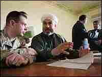 A U.S. Marine meets with a chairman of the Fallujah city council. A U.S. Marine meets with a chairman of the Fallujah city council.