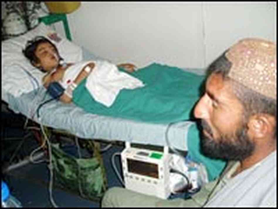 Said Marjan sits beside his sister's hospital bed in Kandahar. Said Marjan sits beside his sister's hospital bed in Kandahar.