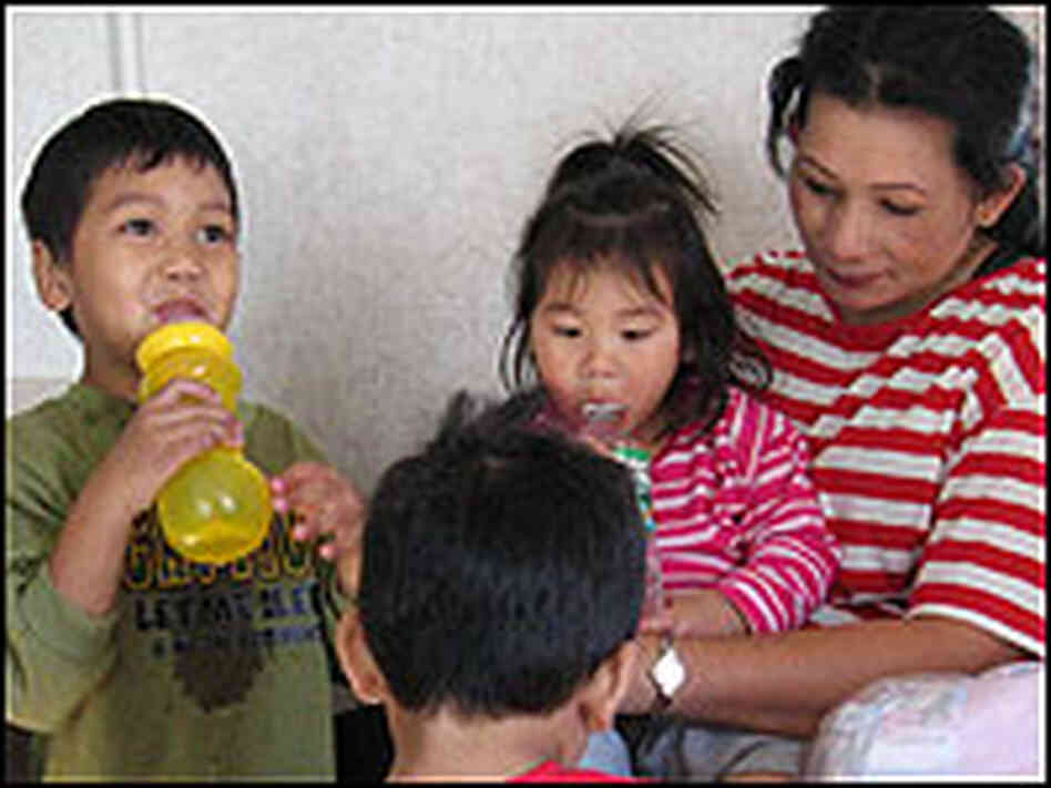 Mali Hoat with several of her children in a FEMA trailer.