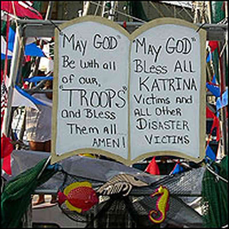 A sign on a fishing boat asks God to bless Katrina victims and U.S. troops.