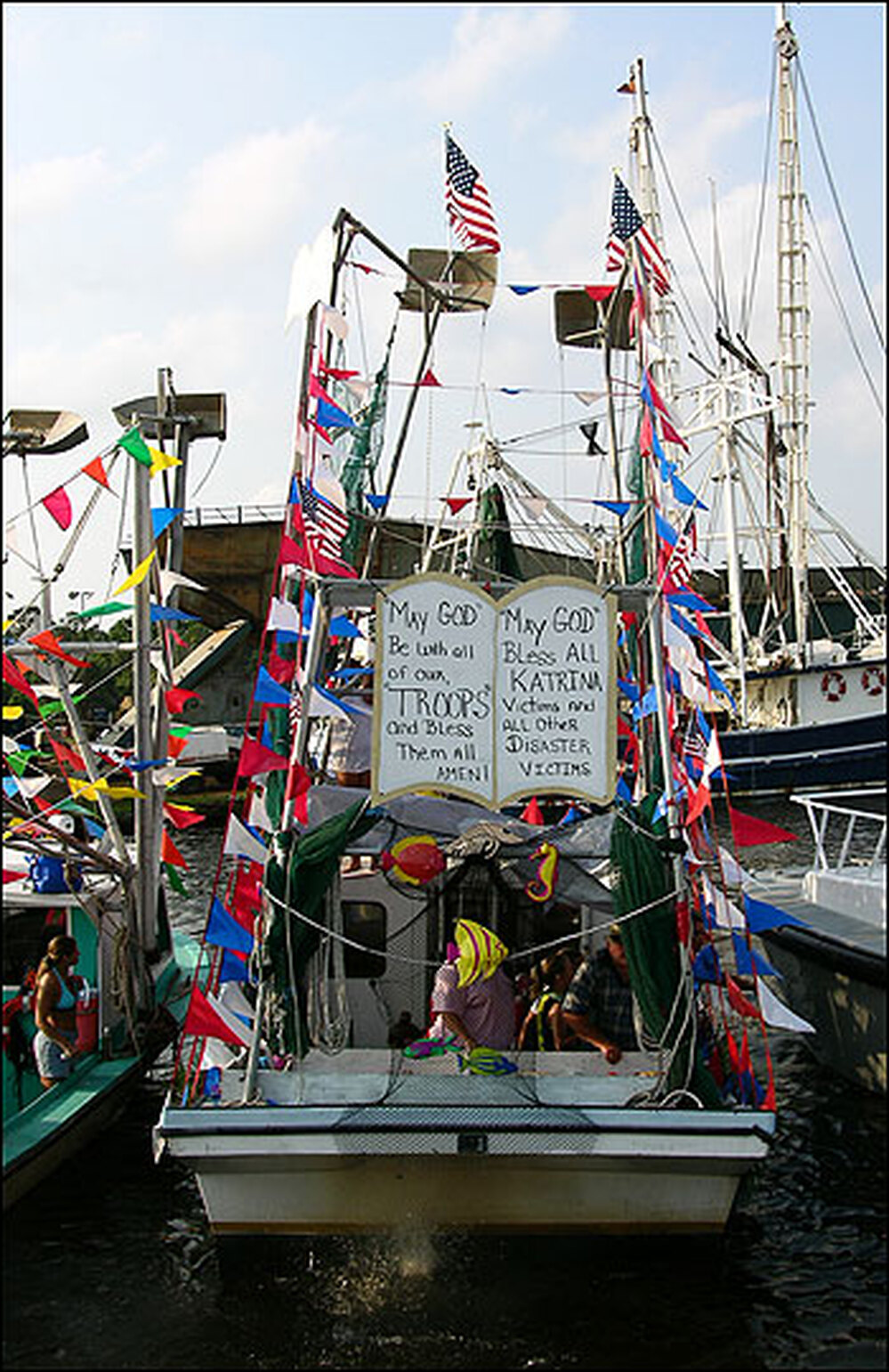 A sign on a fishing boat asks God to bless Katrina victims and U.S. troops.