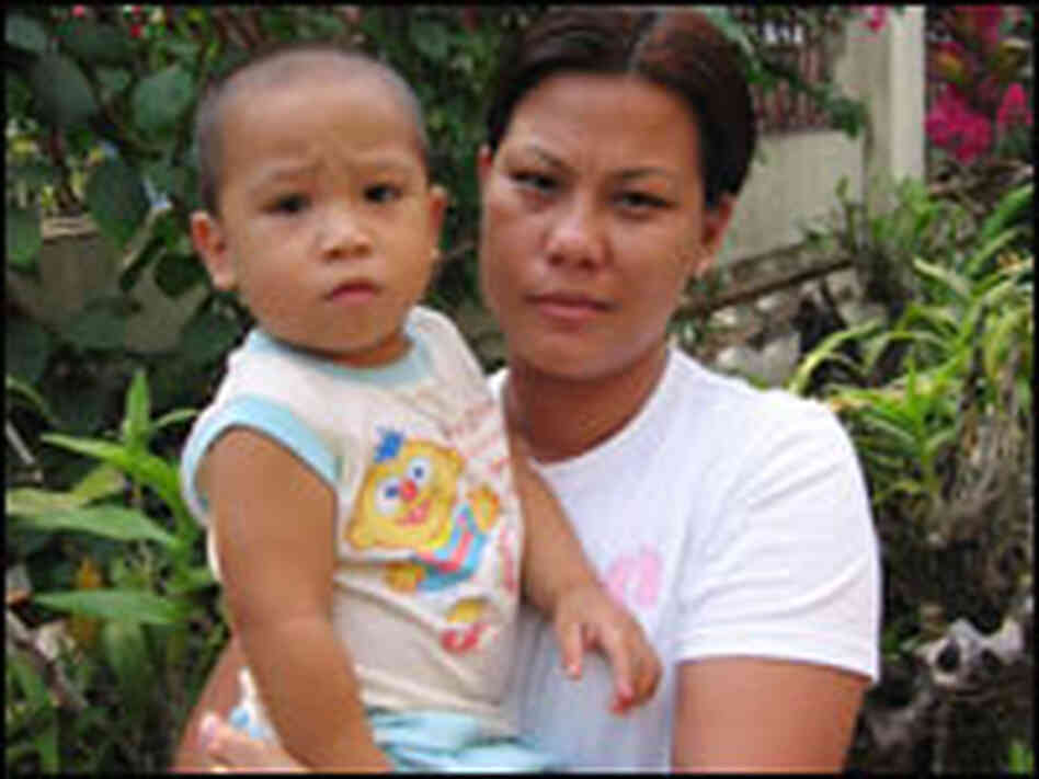 Ana Lobo stands outside her house with her son Tristan Ana Lobo stands outside her house with her son Tristan