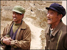 Wei Zijian (L) and his cousin Wei Xiaowu in the courtyard of the younger Wei's home. 